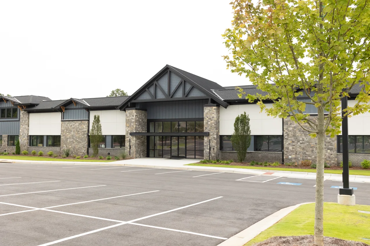 Exterior of the building where Hall Dental is located, with parking in front